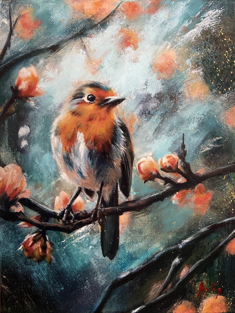 Orange and white bird sitting on a branch with orange flowers blooming around it.